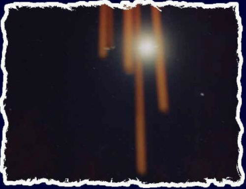 This is a shot of the full moon behind the wind chimes in the back yard in Cornville, AZ