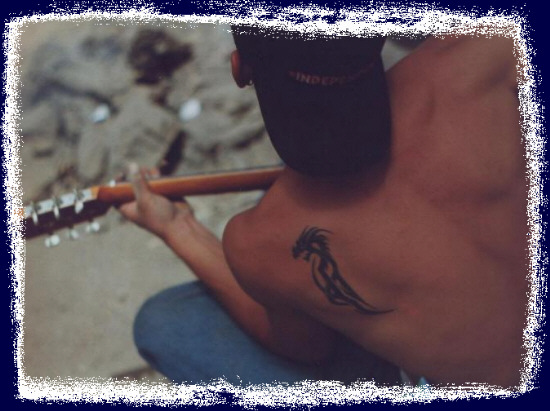 Jarod jammin' on my classical guitar.  That independent hat, the tattoo and this shot describe him totally!