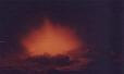 The fire with a friend in the background being consumed in Northern Arizona