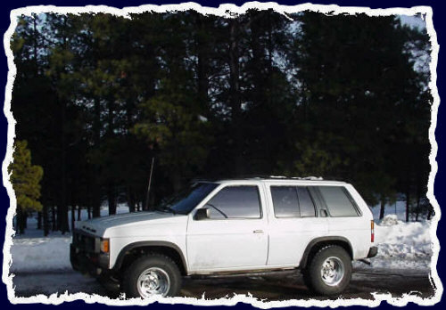 My 1991 4x4 Nissan Pathfinder with extra wide tires, double dark tinting, leather interior, CD and automatic everything - January 2001